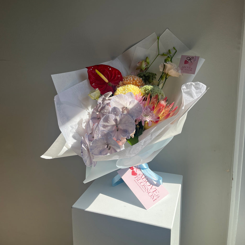 melon pop baby bouquet with orchids