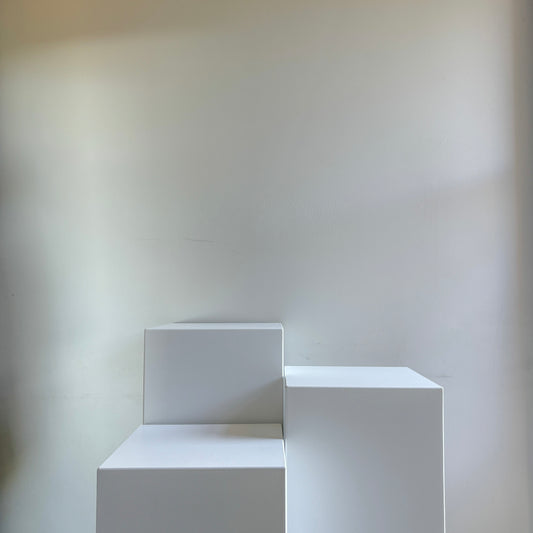 three white acrylic plinths